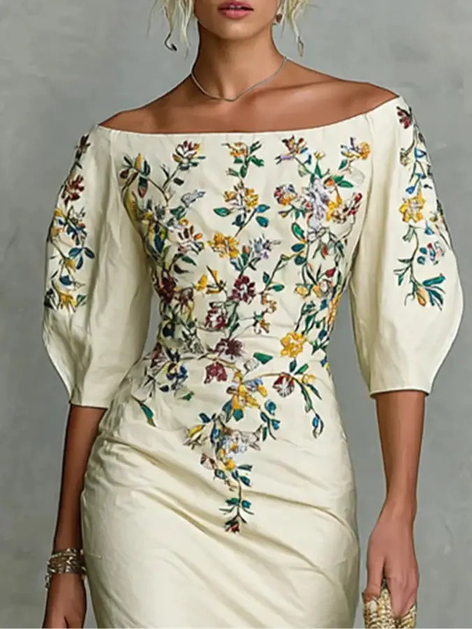 Embroidered off shoulder floral puff sleeve dress in cream satin with vibrant multicolored floral embroidery on the bodice and sleeves.