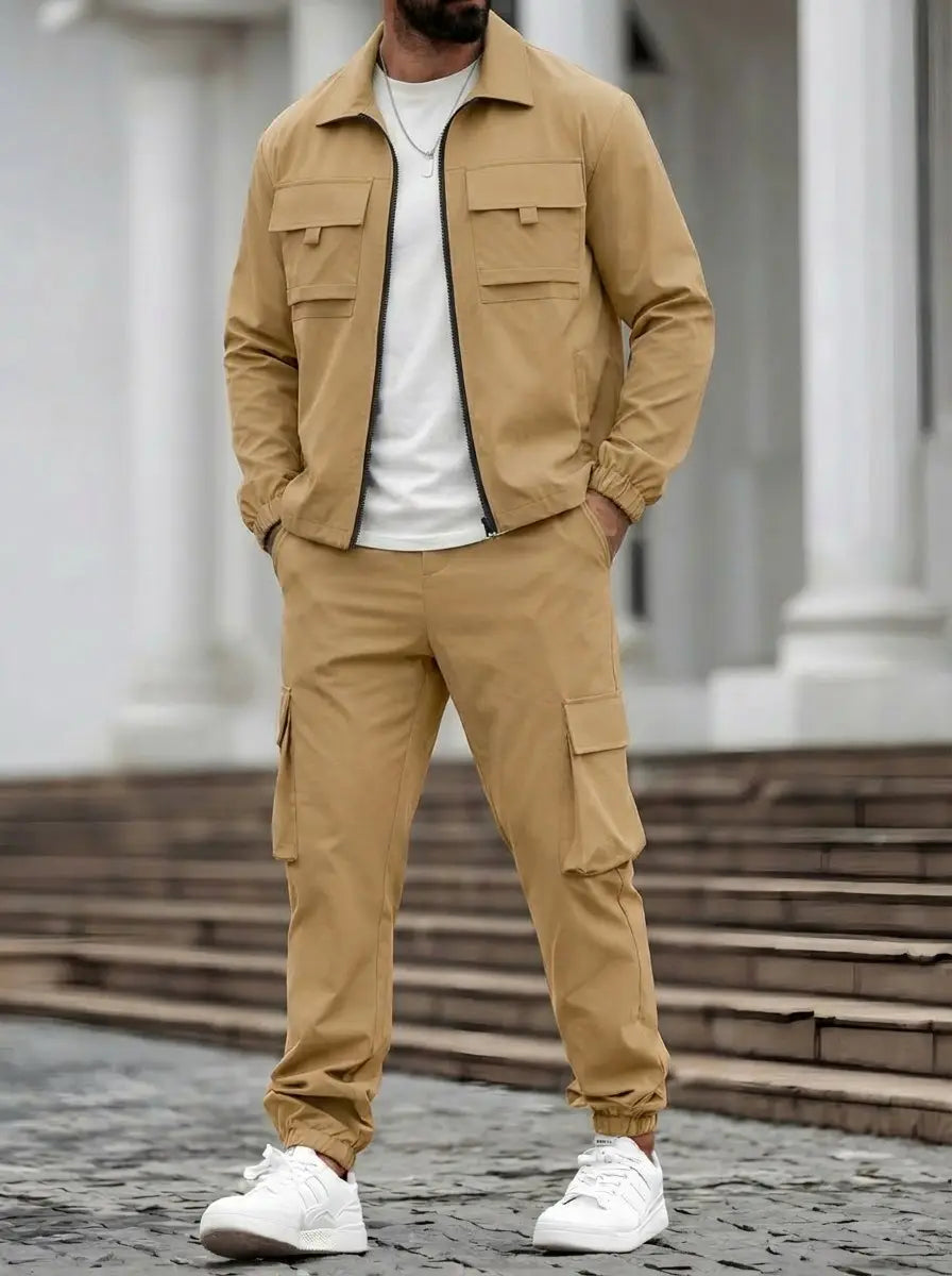 Mens utility zip up workwear set featuring a tan utility jacket with two chest pockets and a black zipper paired with matching cargo pants.