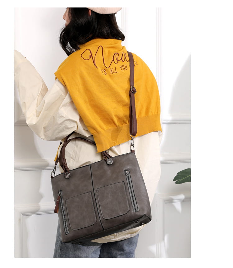 Gray faux leather retro large capacity leather tote crossbody bag with brown handles and zipper pockets designed for versatile use.