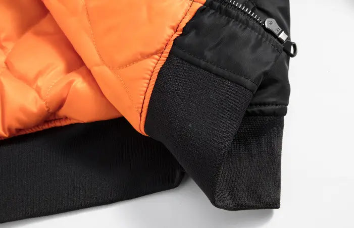 Men’s retro loose flight bomber jacket in orange quilted puffer style with black ribbed cuffs and silver zipper pull designed for durable workwear.