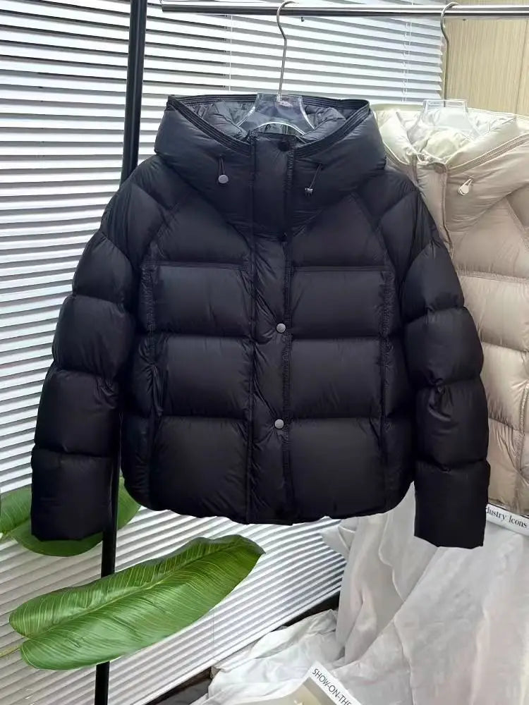 Black puffer jacket loose hooded winter coat featuring a quilted design with a hood and silver-toned buttons.
