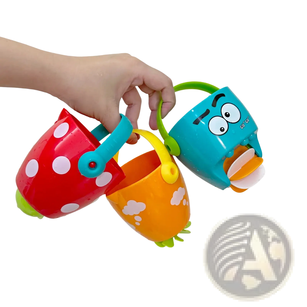 A hand holds three colorful plastic baby bath buckets with playful designs for water spraying toy set use