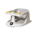Gray plastic baby bath seat with temperature display and suction cups featuring yellow and green textured toys on tray
