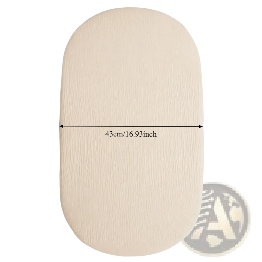 Beige breathable fitted baby crib mattress cover with a subtle textured oval-shaped surface for comfort