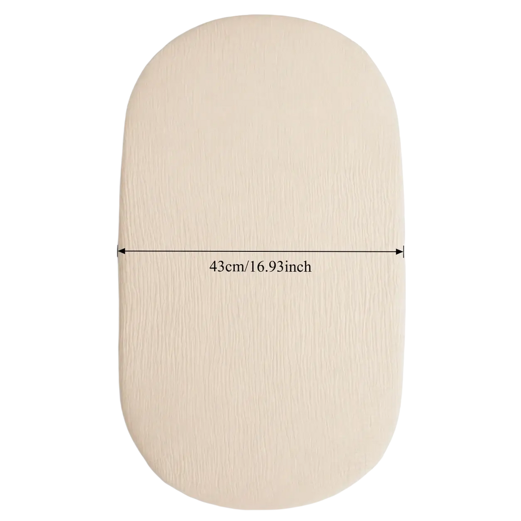 Beige breathable fitted baby crib mattress cover with a subtle textured oval-shaped surface for comfort