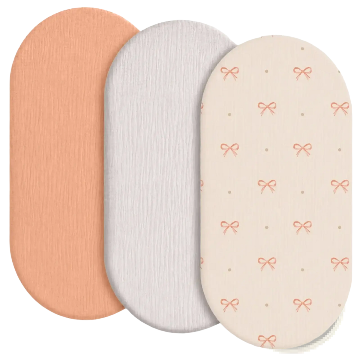 Set of three breathable fitted baby crib mattress covers in peach white and cream with textured pink bow patterns
