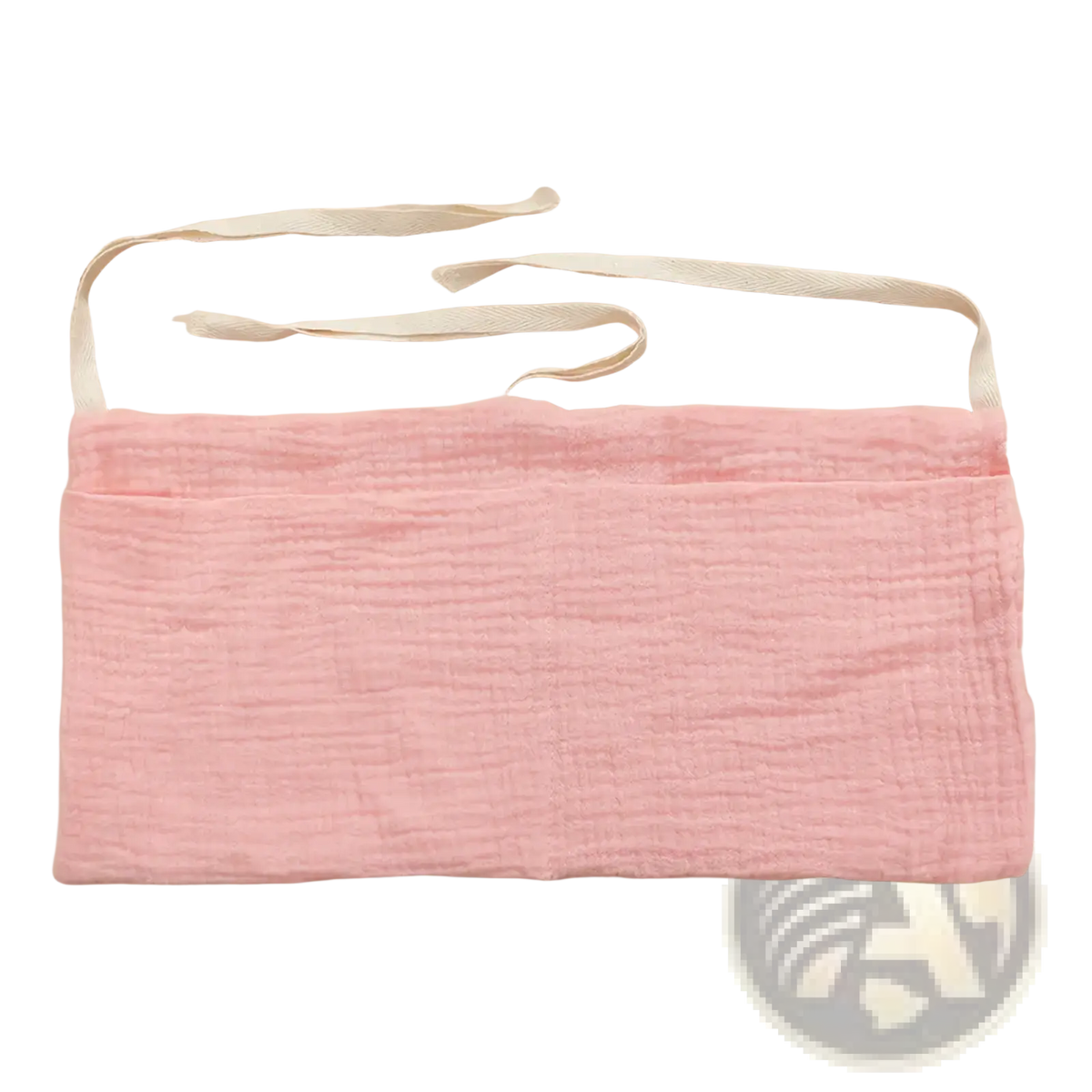 A soft pink cotton baby crib storage bag bedside organizer with textured fabric and two adjustable white ribbon ties