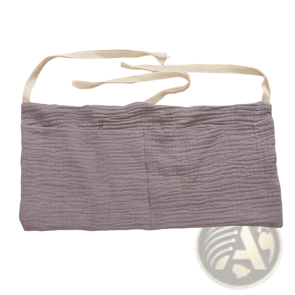 Baby crib storage bag bedside organizer made of soft lavender cotton fabric with two front pockets and adjustable straps
