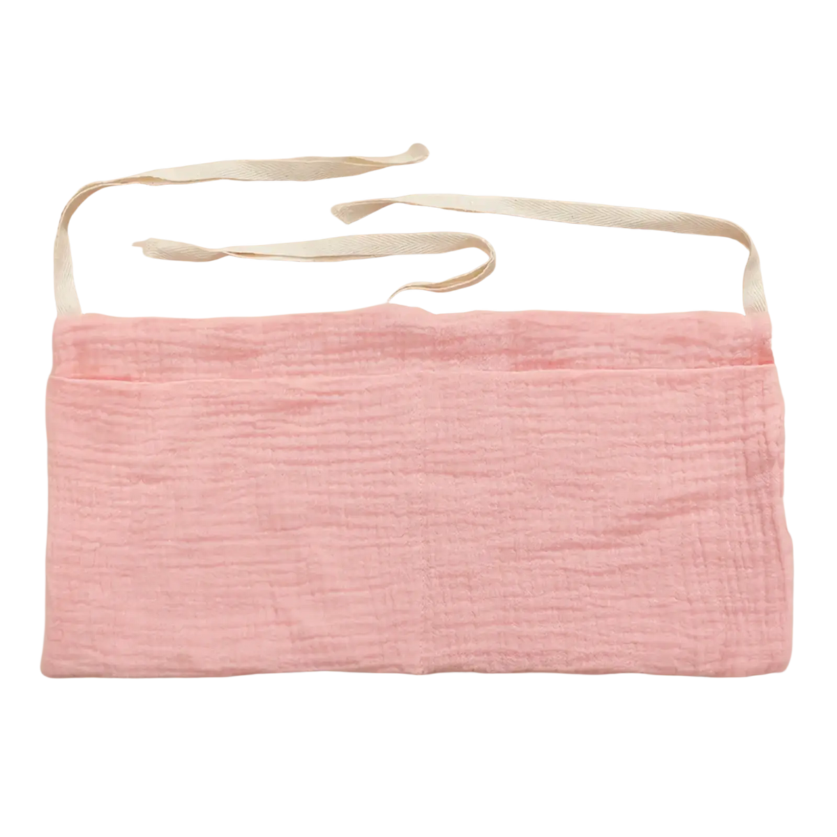 A soft pink cotton baby crib storage bag bedside organizer with textured fabric and two adjustable white ribbon ties