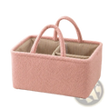 Pink fuzzy fabric baby diaper organizer storage basket with striped interior and two handles for easy carrying
