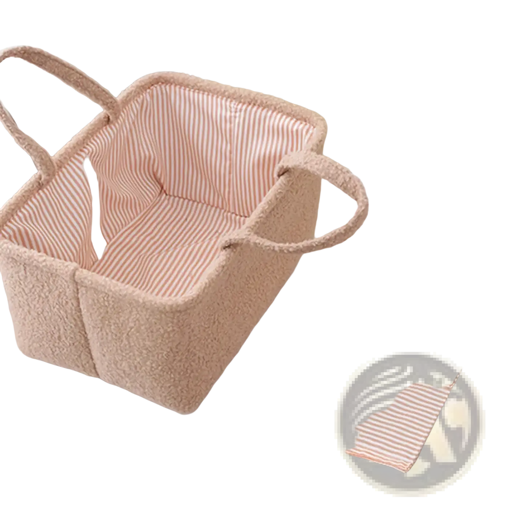 Baby diaper organizer storage basket in soft blush plush fabric with striped interior lining and sturdy handles
