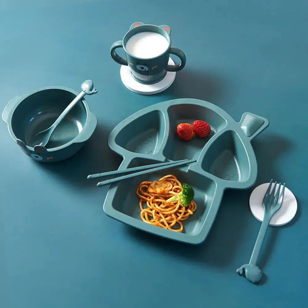 Blue plastic fish-shaped silicone toddler feeding plate with 3 compartments and a handle for children’s meals