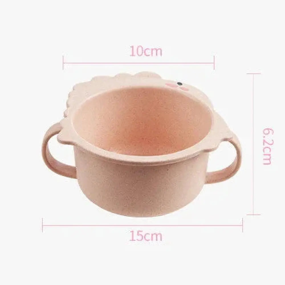 Pastel pink two-handled children’s bowl with a cute lion face design made of silicone for toddler feeding sets