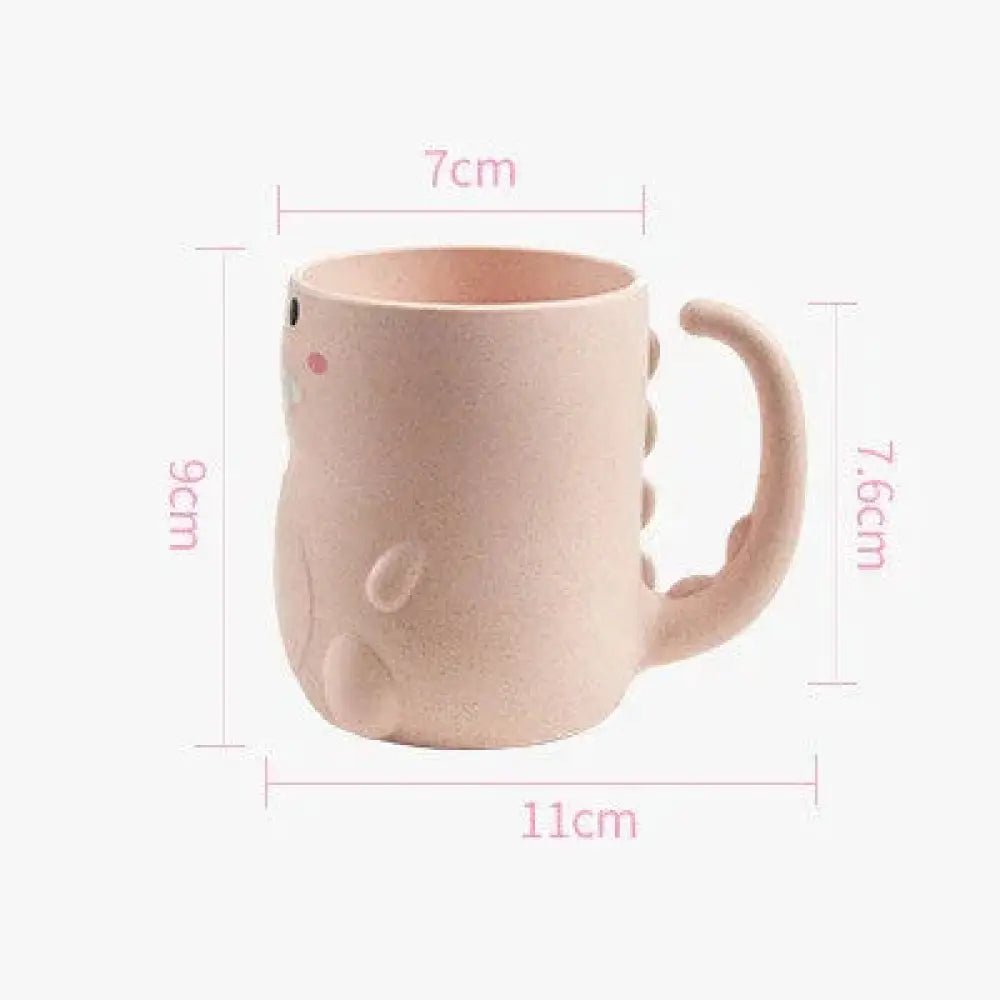 Pastel pink ceramic dinosaur-shaped mug with small black eyes and rosy cheeks from 3-compartment silicone toddler feeding set