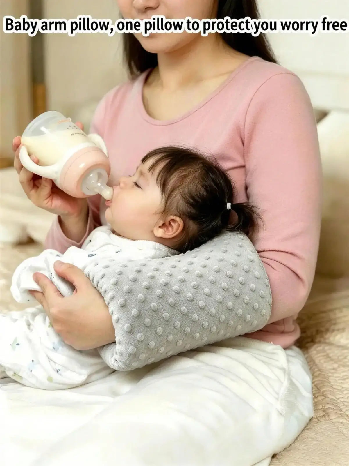 Gray textured baby feeding arm pillow with soft dotted surface nursing support cushion for comfortable feeding
