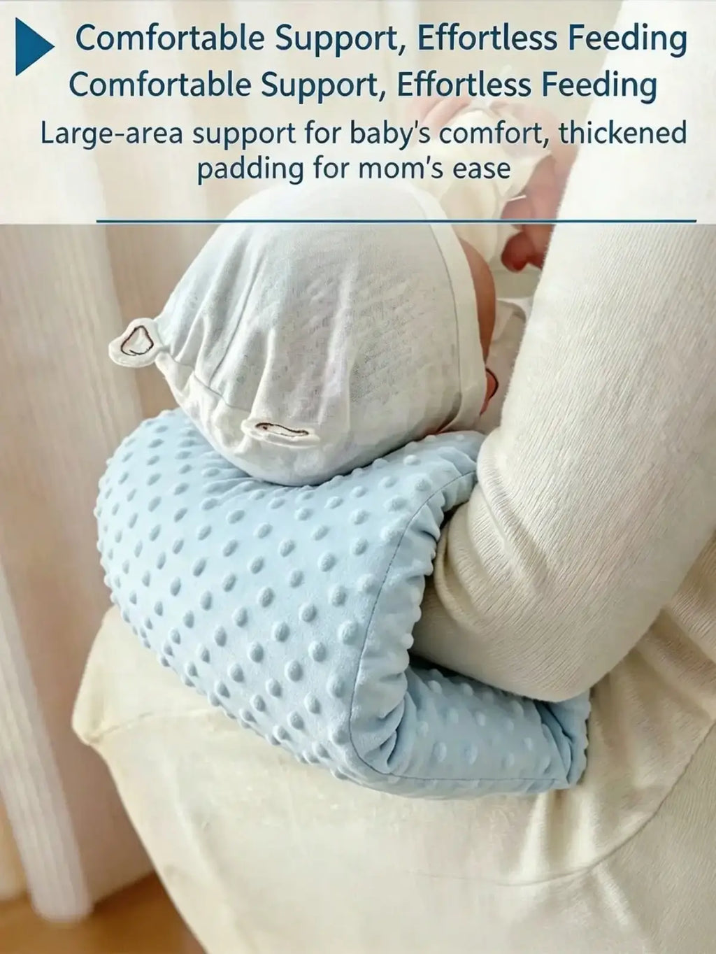 Light blue textured baby feeding arm pillow with dotted surface and soft padding for comfortable nursing support