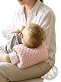 Pink textured baby feeding arm pillow with soft raised dot pattern for nursing support cushion