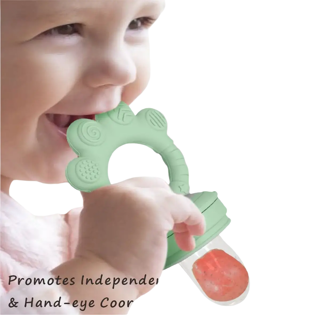Mint-green silicone baby fruit feeder with textured flower top and clear base holding red fruit puree in freezer tray set