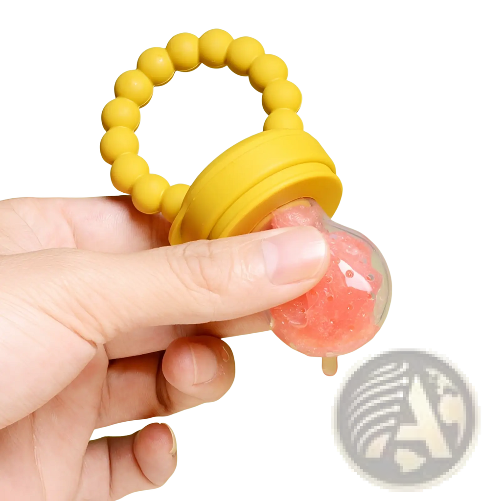 Yellow silicone baby fruit feeder teether pacifier set with clear compartment containing pink fruit puree