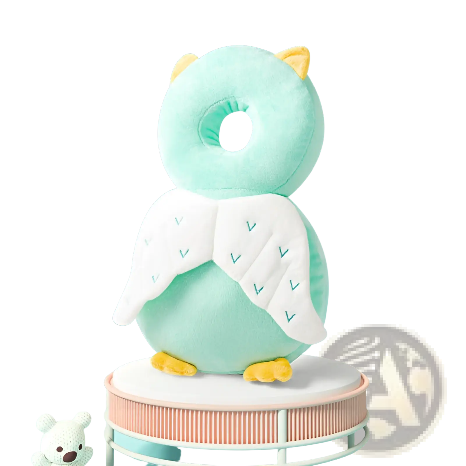 A soft mint green plush owl baby head protector anti fall neck pillow with white embroidered wings and yellow ears and feet