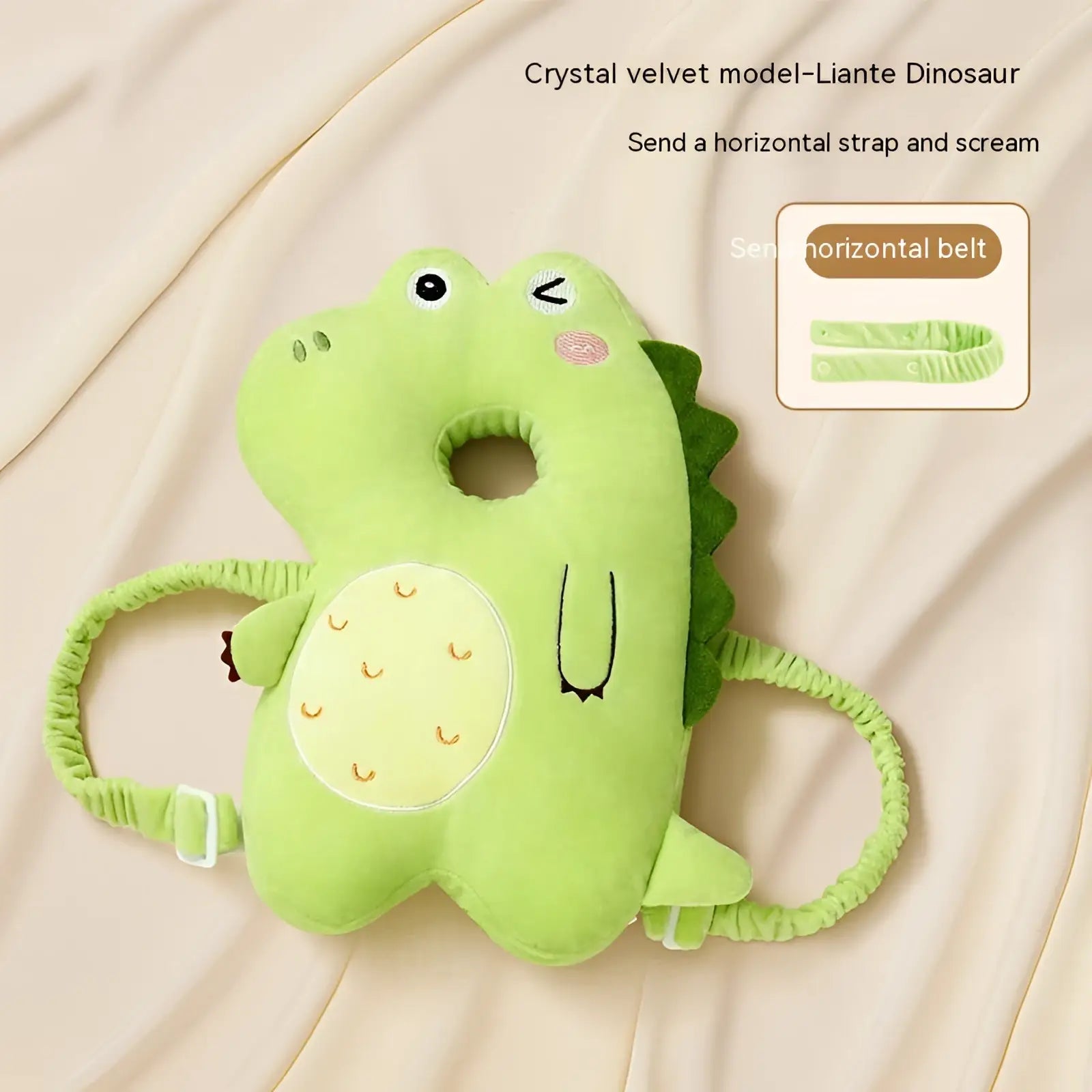 A soft light green plush dinosaur baby head protector pillow with textured belly and adjustable elastic straps for fall protection