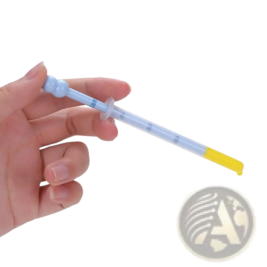 A translucent blue plastic baby medicine dispenser dropper feeder with a yellow tip and measurement markings held in hand