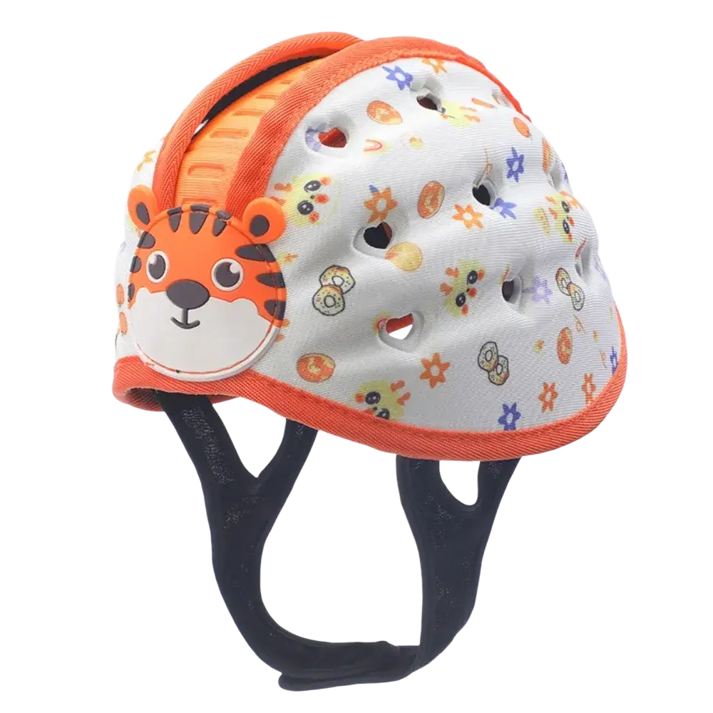 White toddler safety helmet with orange trim, cartoon tiger face, colorful animal prints, and ventilation holes for breathability