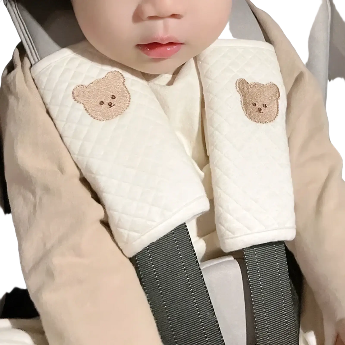 Cream-colored quilted baby seat belt cover with embroidered teddy bear faces for animal shoulder pad comfort