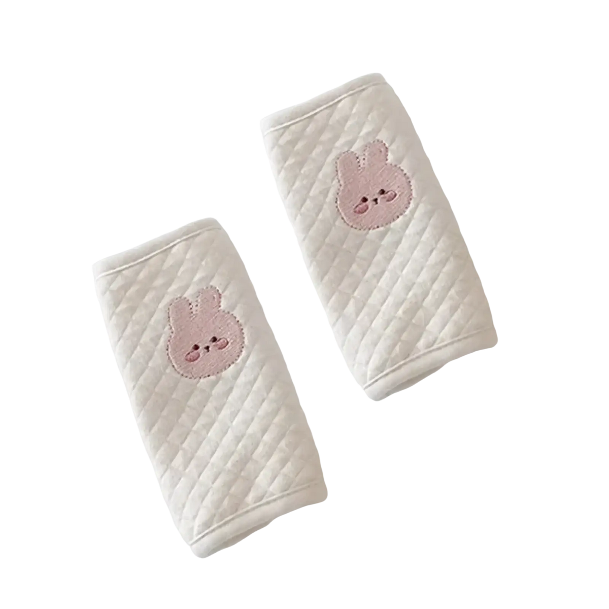 Cream-colored quilted baby seat belt cover with embroidered pink bunny faces for shoulder pad protection