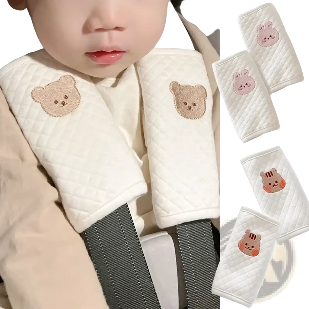 White quilted baby seat belt cover with embroidered bear and animal faces in beige pink and orange tones