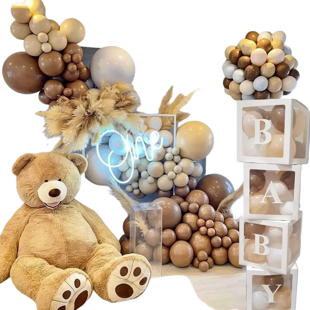 A plush tan teddy bear with white paw pads sits in front of baby shower balloon boxes 4 pcs transparent letter blocks