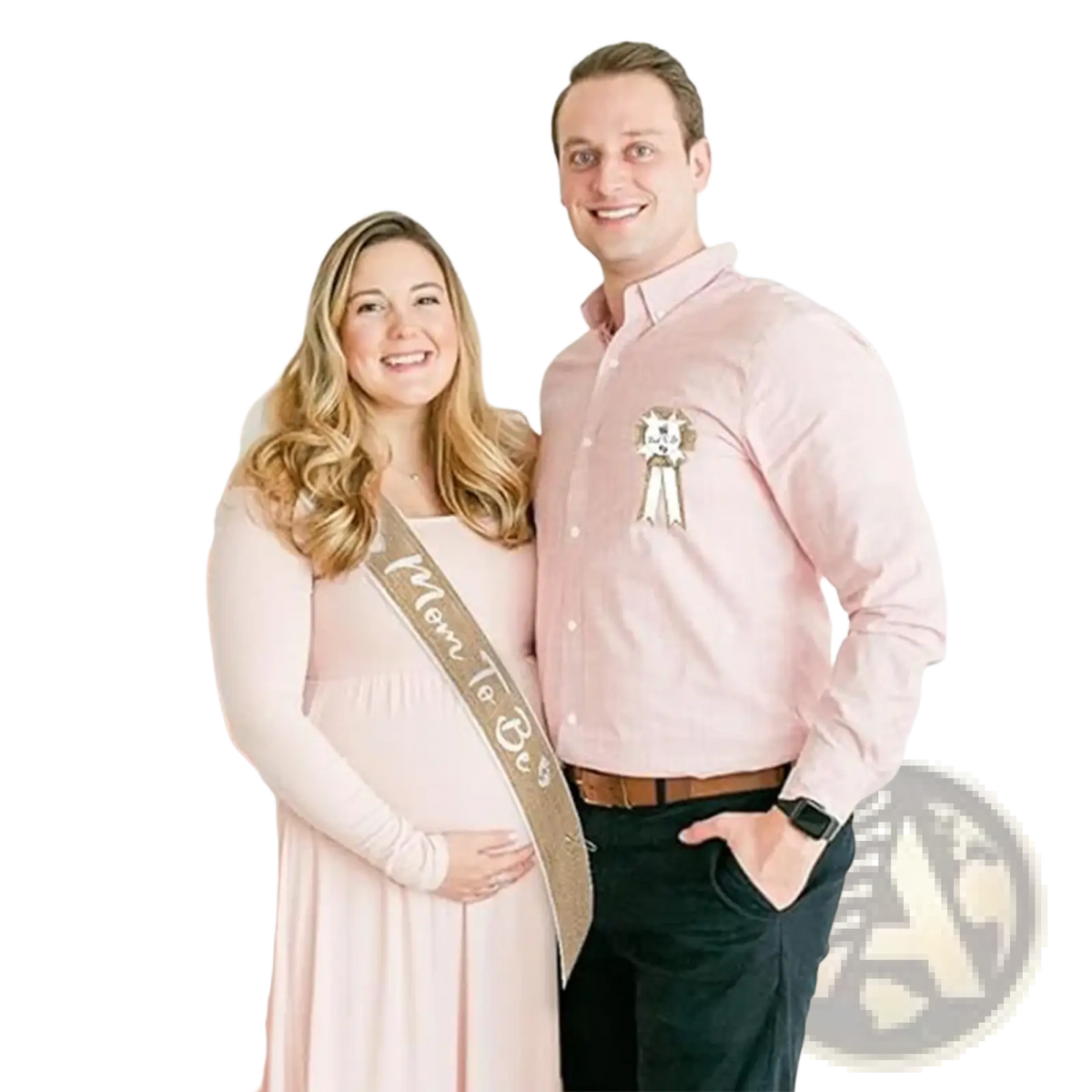 The woman wears a soft pink long-sleeved maternity dress with flowing skirt and ruching paired with baby shower burlap mom to be sash and badge set