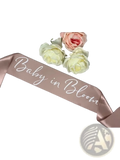 Rose-gold satin baby shower sash with baby in bloom white cursive script for mum to be maternity celebration