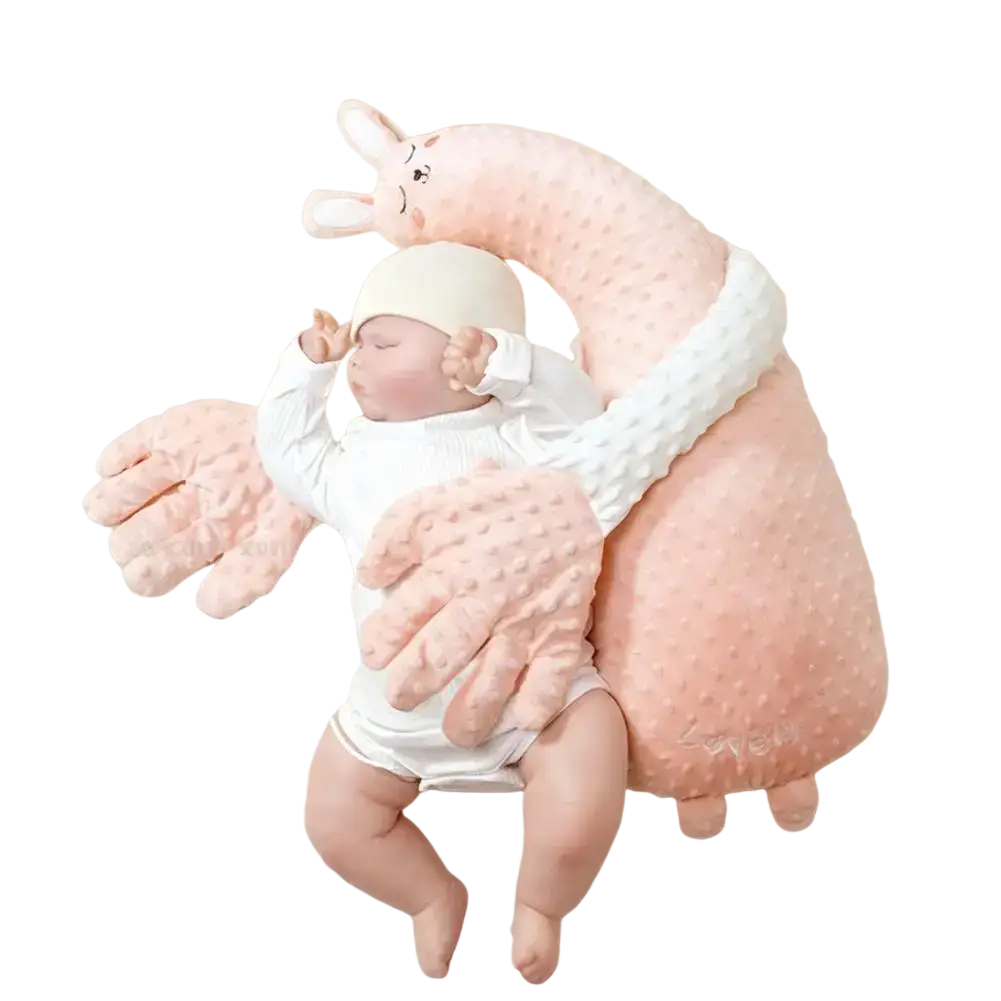 Soft pink plush bunny-shaped baby sleep aid pillow with textured fabric and embroidered facial features