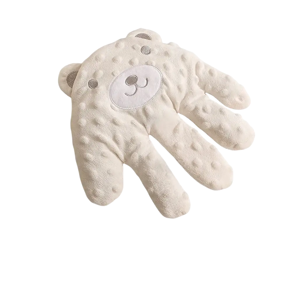 Soft cream-colored plush baby mittens with textured bumpy surface and embroidered bear face for baby sleep aid soothing palm pillow