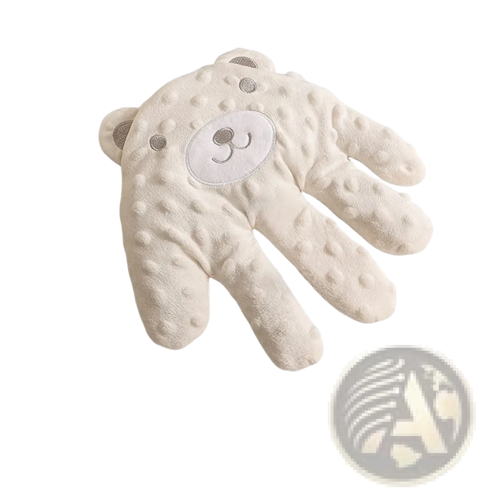 Soft cream-colored plush baby mittens with textured bumpy surface and embroidered bear face for baby sleep aid soothing palm pillow