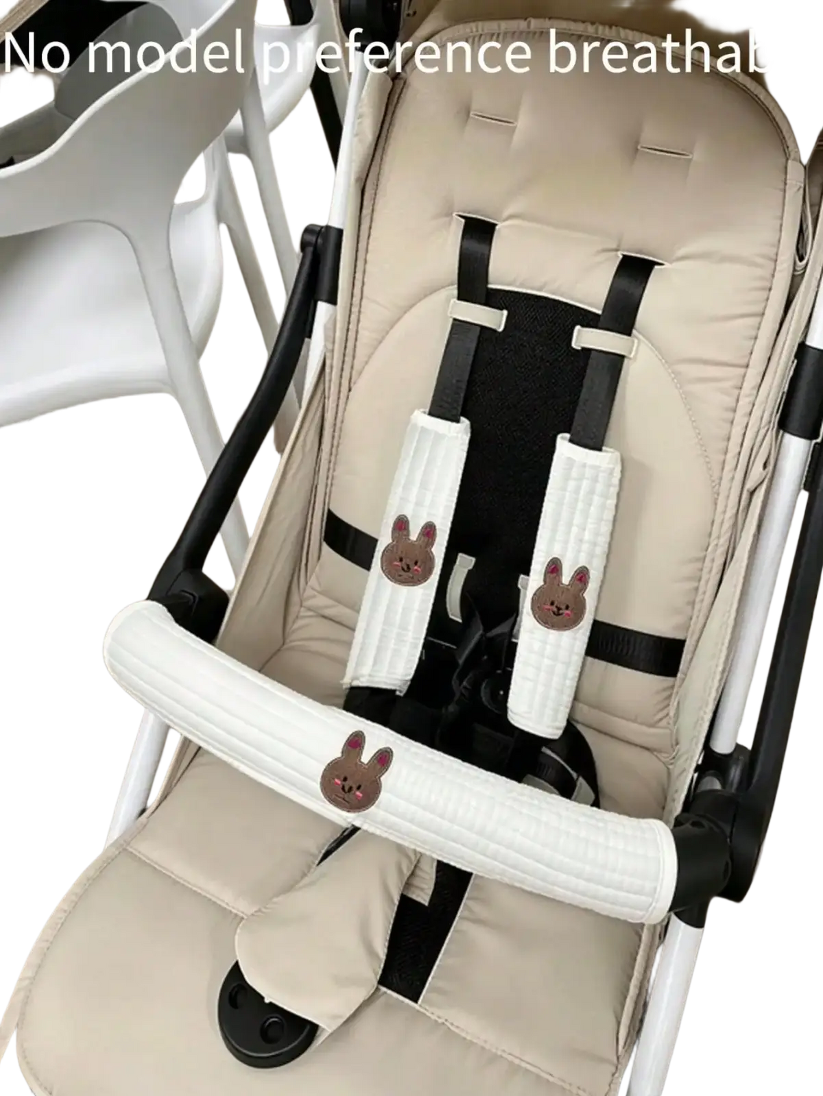 Beige and black baby stroller with plush bunny-themed harness padding from embroidered bear cover accessory set