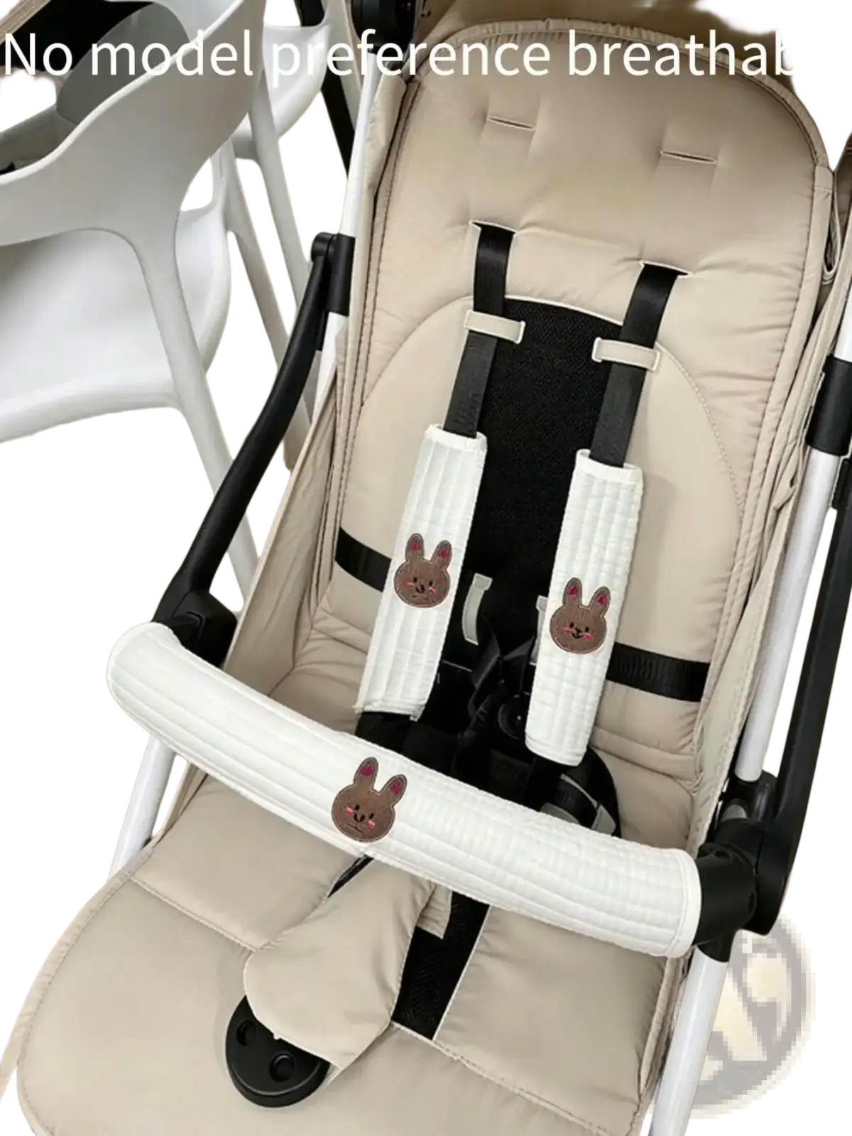 Beige and black baby stroller with plush bunny-themed harness padding from embroidered bear cover accessory set