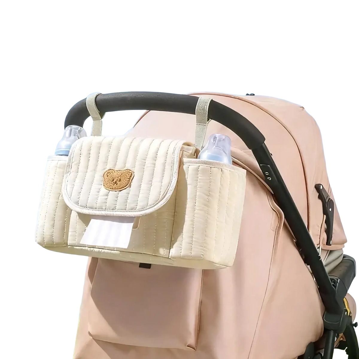 Cream-colored quilted baby stroller organizer bag with teddy bear patch and two bottle holders for convenient storage
