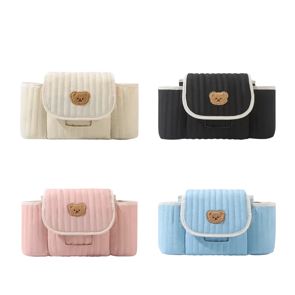 Quilted baby stroller organizer bag in cream black pink or sky blue with a tan embroidered teddy bear patch on the flap