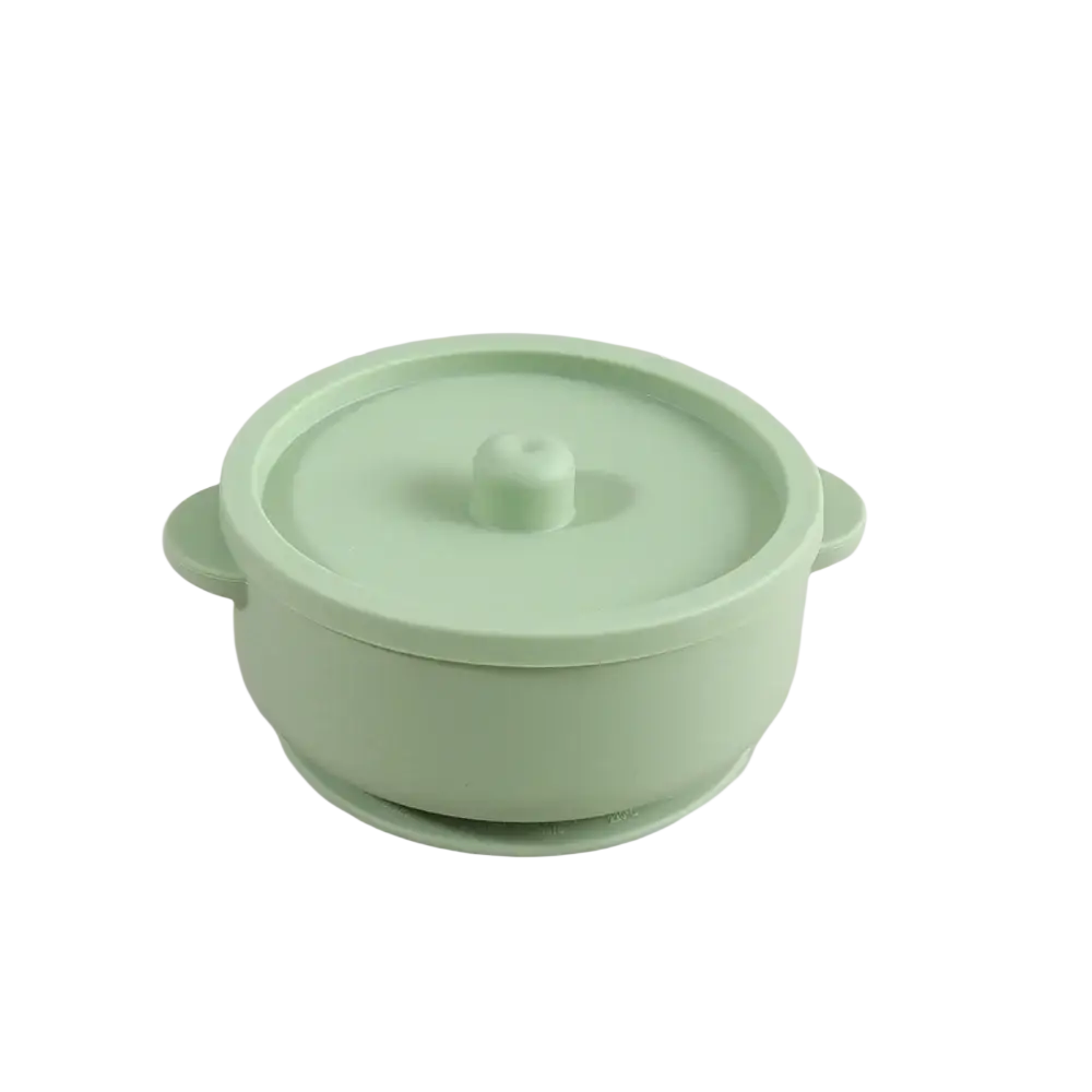 Pastel green silicone baby training bowl with rounded handles and matching lid for weaning stainless steel dish