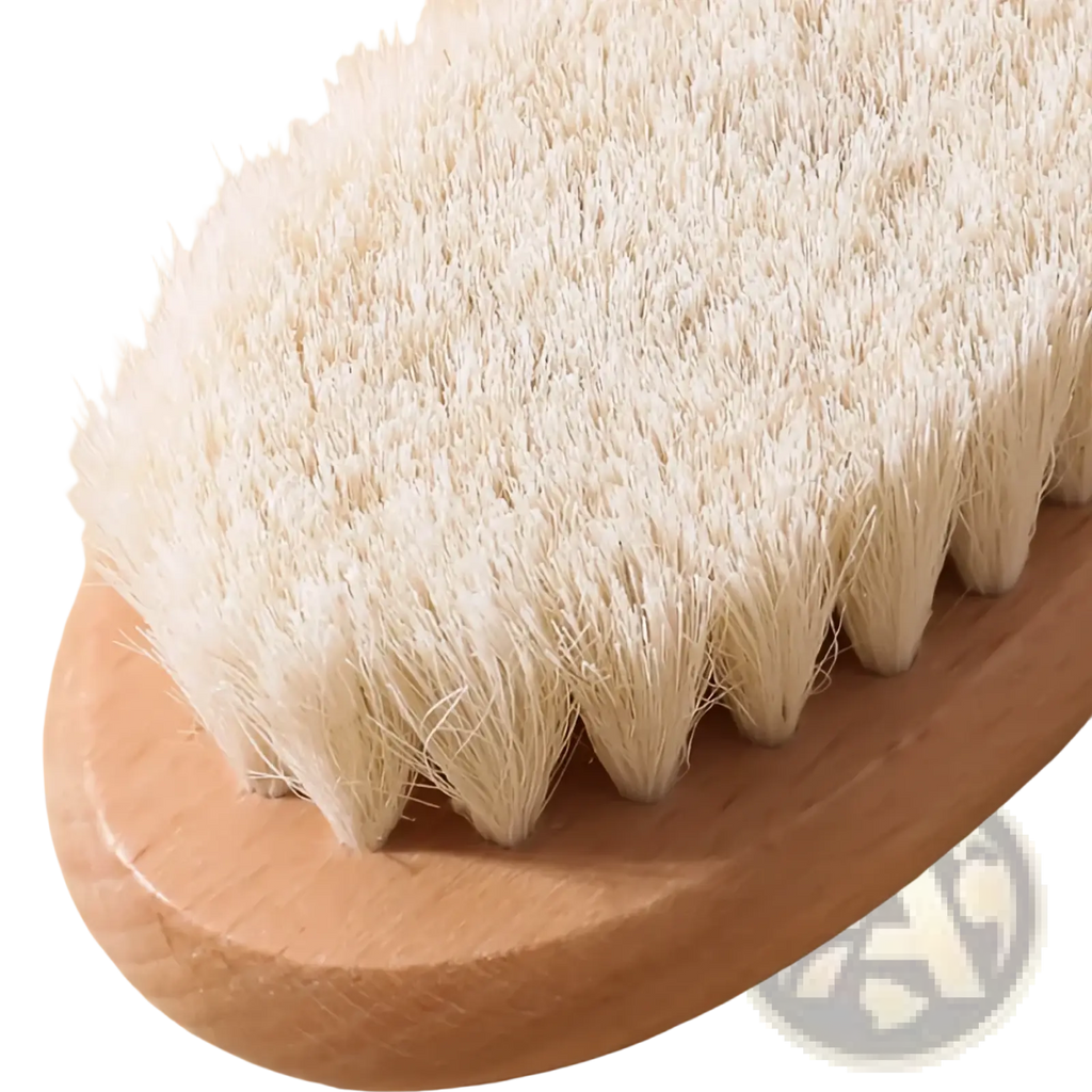 A natural wood-handled body brush with dense soft white bristles in a baby wooden grooming set and healthcare kit