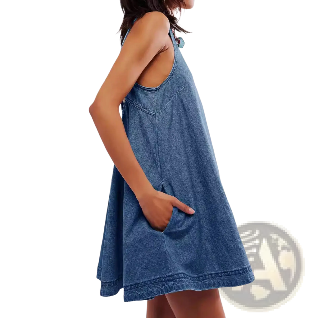 A sleeveless medium-wash denim mini dress with a relaxed fit front pockets and backless bow accent