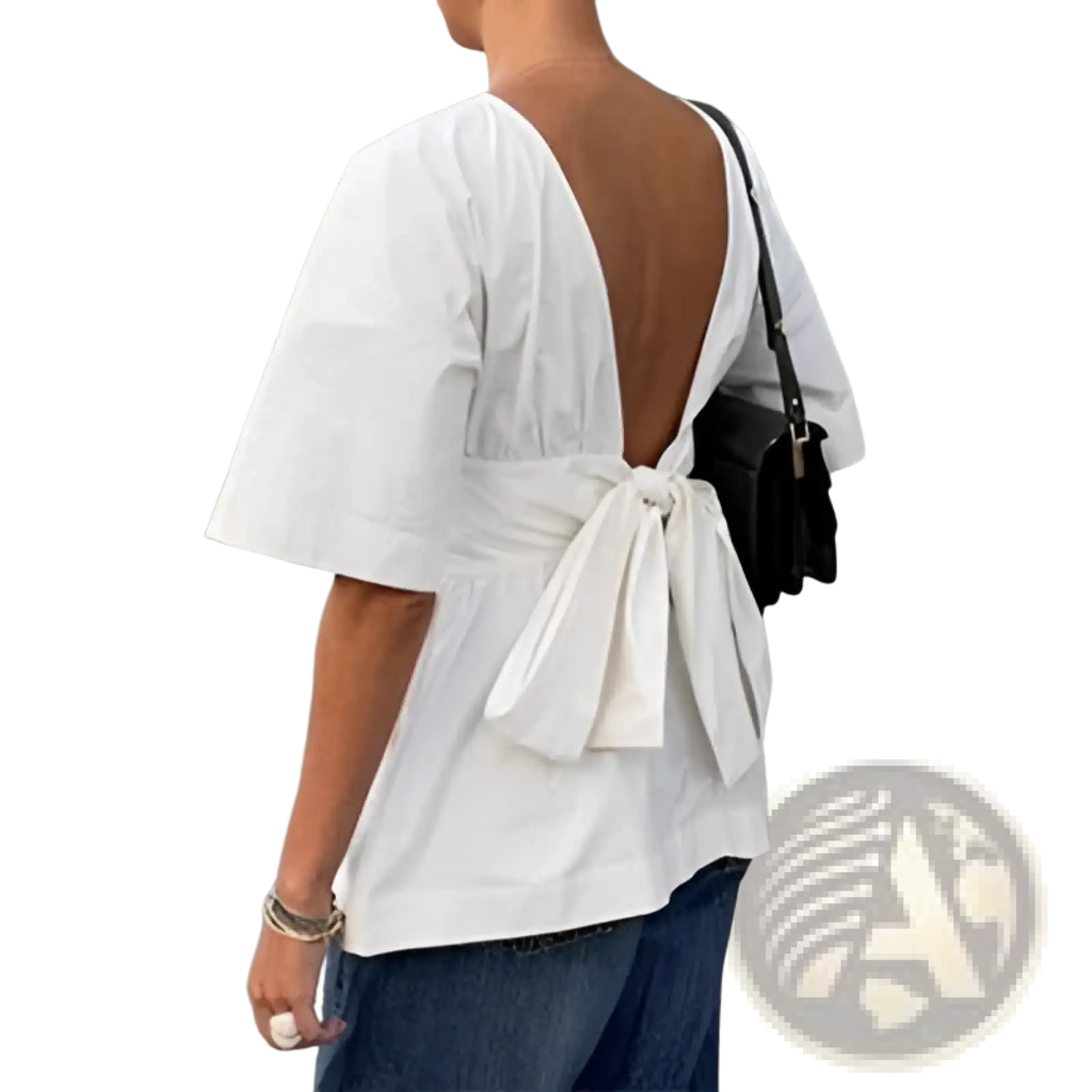 White short sleeve cotton blouse with open-back design and tie back bow shown from the back side