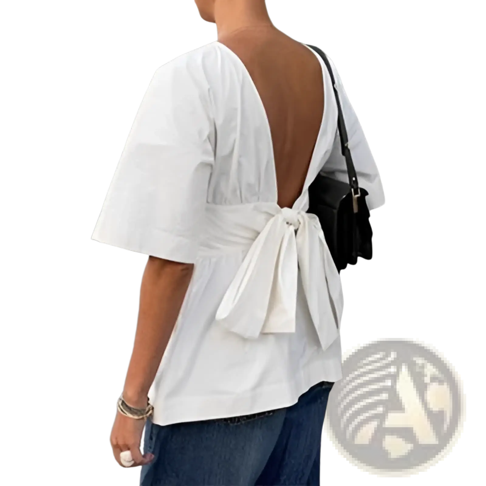 White short sleeve cotton blouse with open-back design and tie back bow shown from the back side