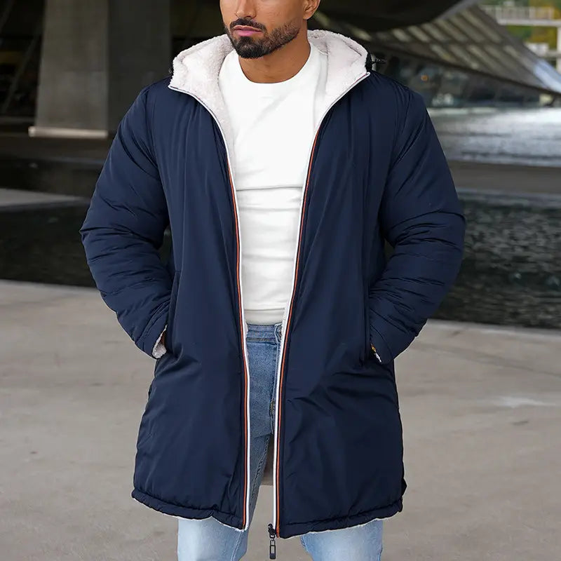 Navy blue men reversible shearling winter hooded puffer coat with white fleece lined hood and red white and navy trim along the zipper.