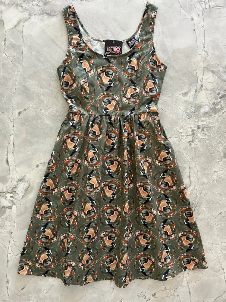 Olive cotton fit and flare sleeveless dress with vintage-inspired tan and black motorcycle helmet print