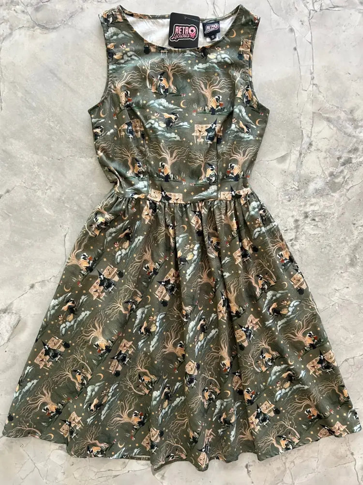 Olive green sleeveless cotton dress with whimsical badger and mouse vintage wizard print and fitted flared design