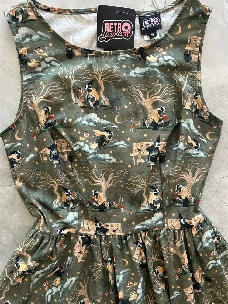 Olive green sleeveless cotton dress with whimsical black beige and gold witch wizard print by Badger and Mouse