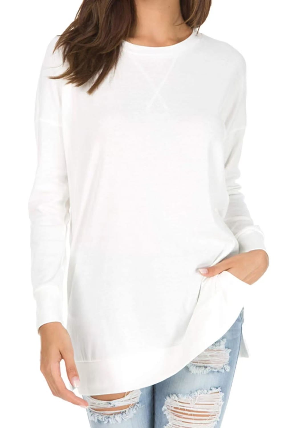White long-sleeved knit sweater with a relaxed fit, split front, and side pockets.